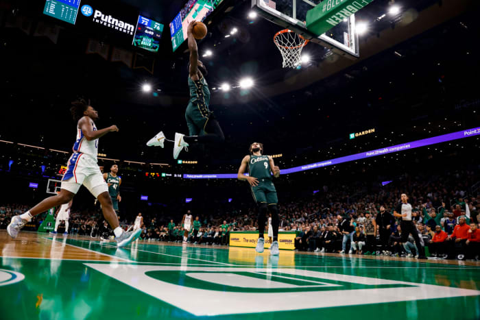 Boston Celtics guard Jaylen Brown (7) goes in for a dunk past Philadelphia 76ers guard Tyrese Maxey (0) during the third quarter at TD Garden.
